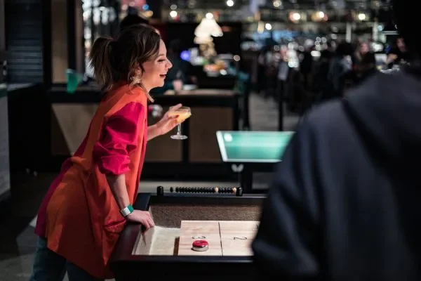 Woman playing indoor shuffleboard